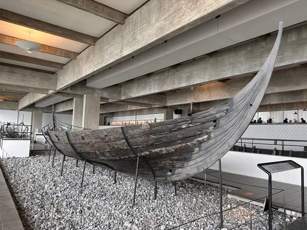 Ancient Viking ship displayed in modern museum hall