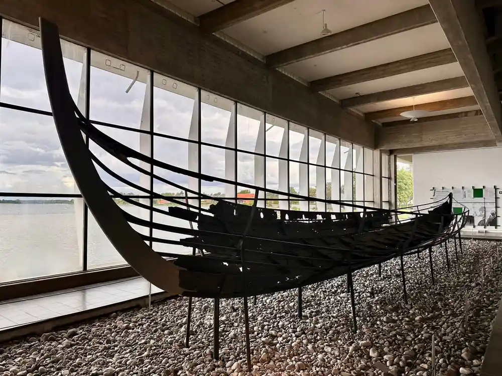 Black Viking ship replica in modern museum gallery