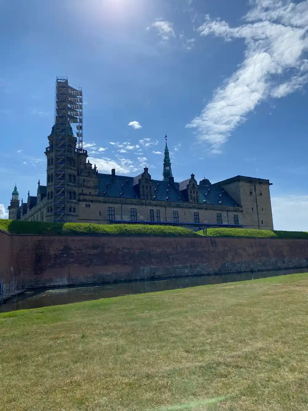 Large castle on hilltop with moat and fortifications