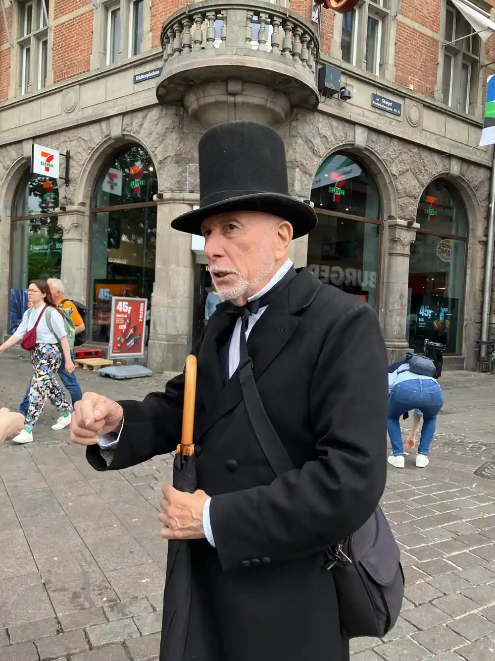 Man in top hat and formal clothes performing street magic