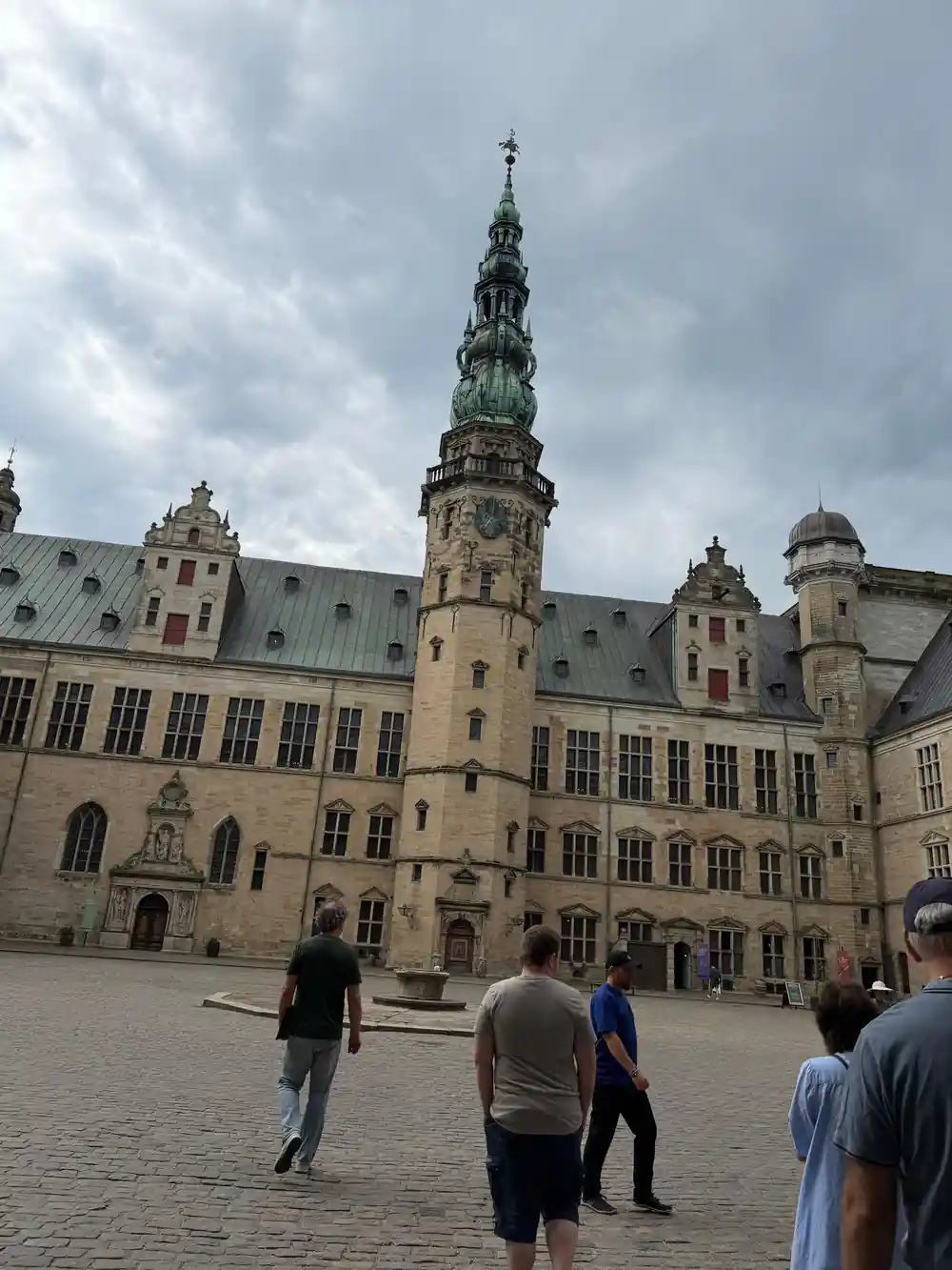 Medieval castle courtyard with ornate spire and tower