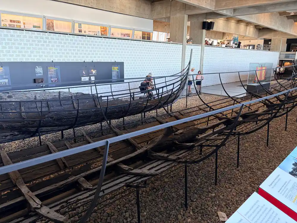 Multiple wooden Viking ship replicas in museum display