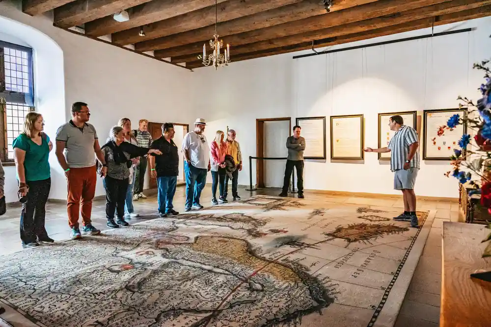 Museum interior with visitors viewing artwork on walls