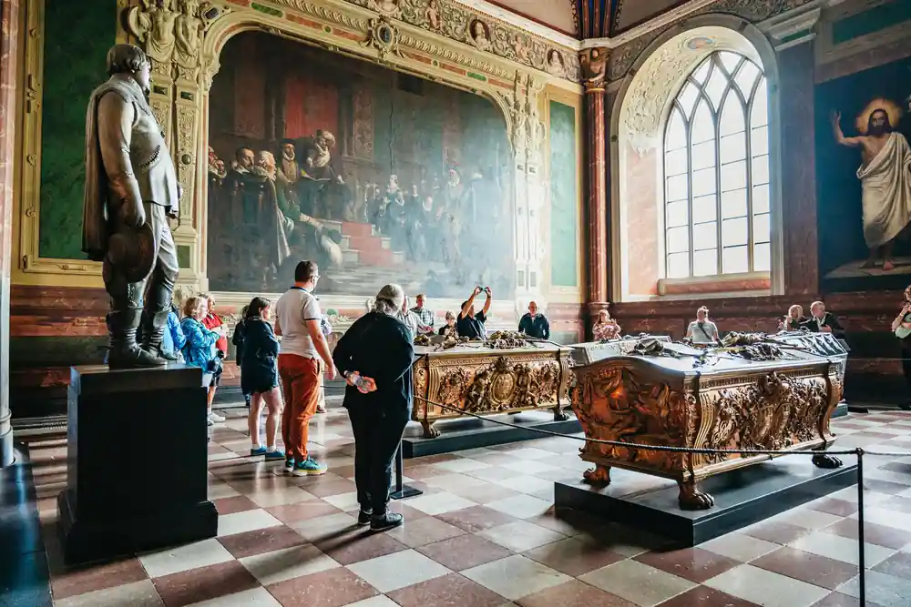 Ornate altarpiece with multiple painted religious scenes in chapel
