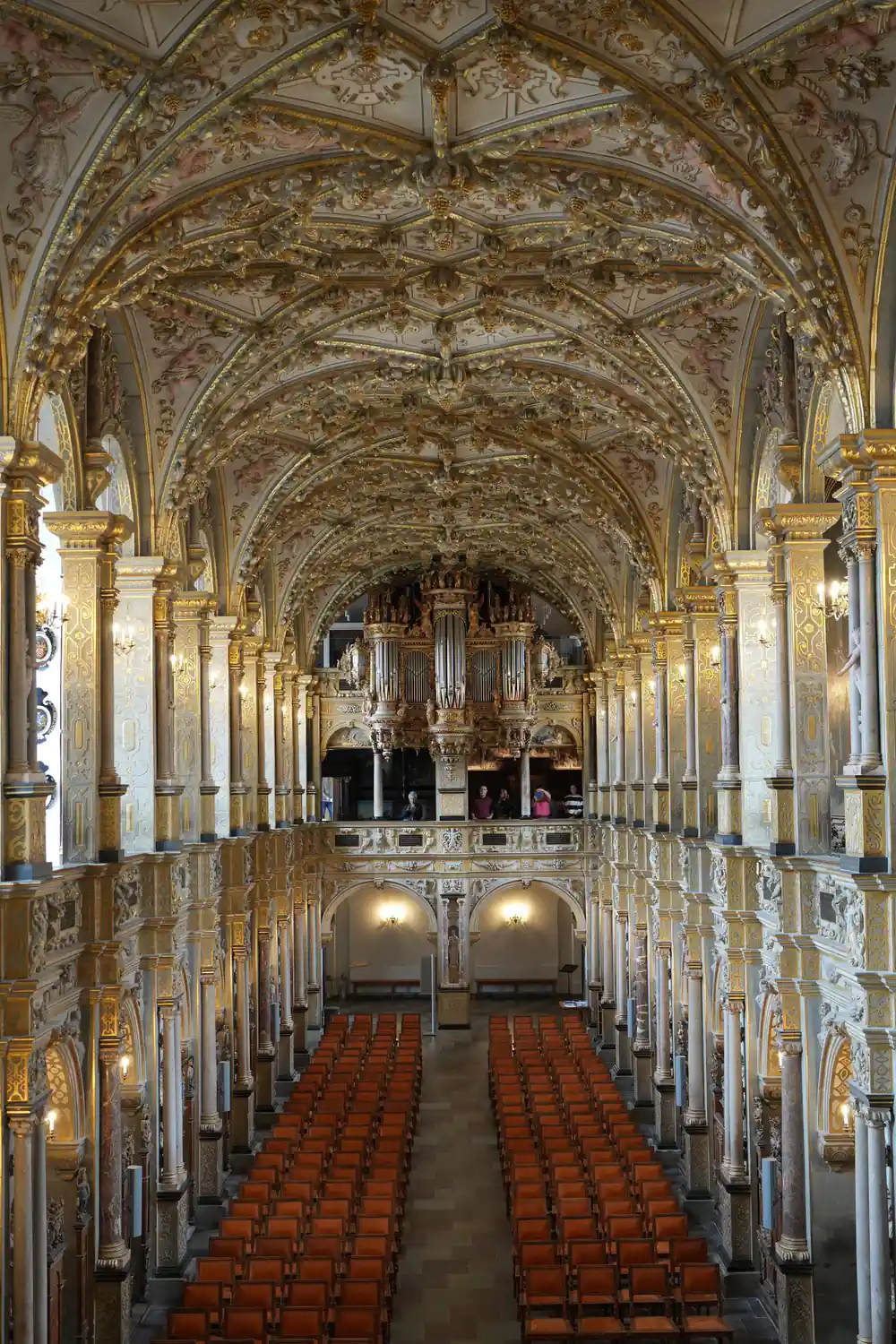 Ornate church interior with vaulted ceiling and organ