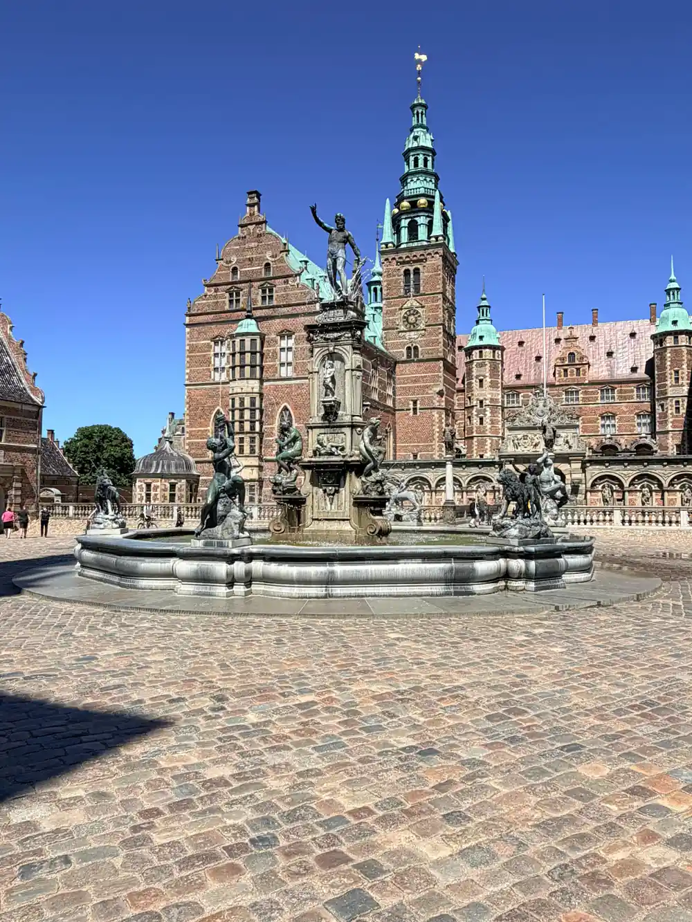 Ornate Renaissance palace with statue and fountain