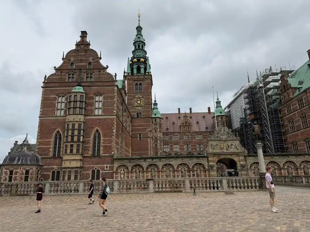 Red brick buildings with spires around plaza courtyard