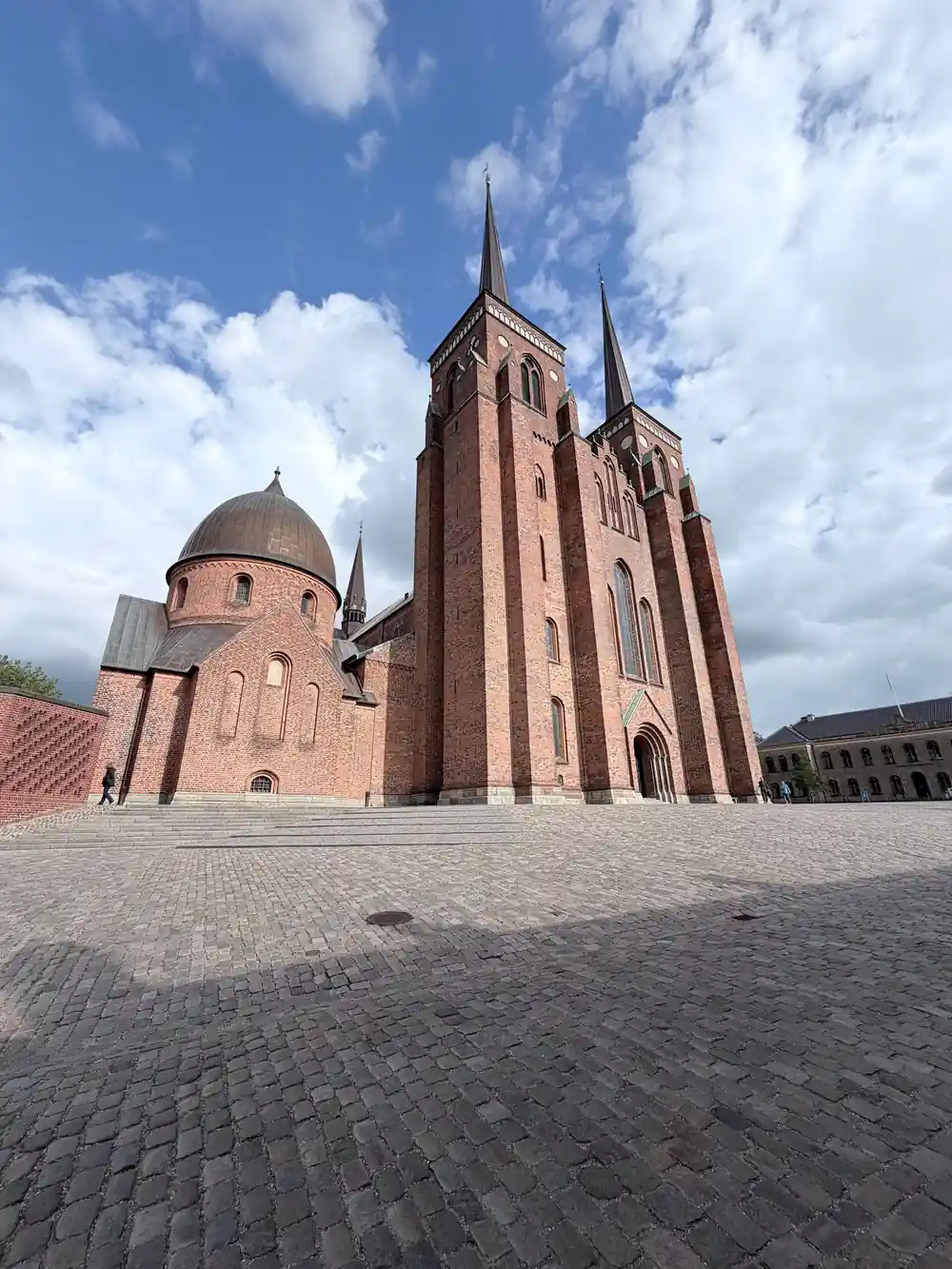 Red brick church with copper dome and courtyard