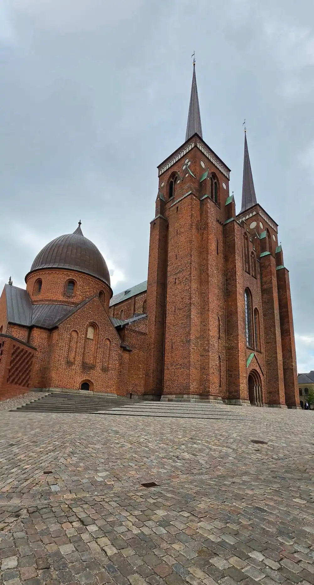 Red brick church with dome and twin spires