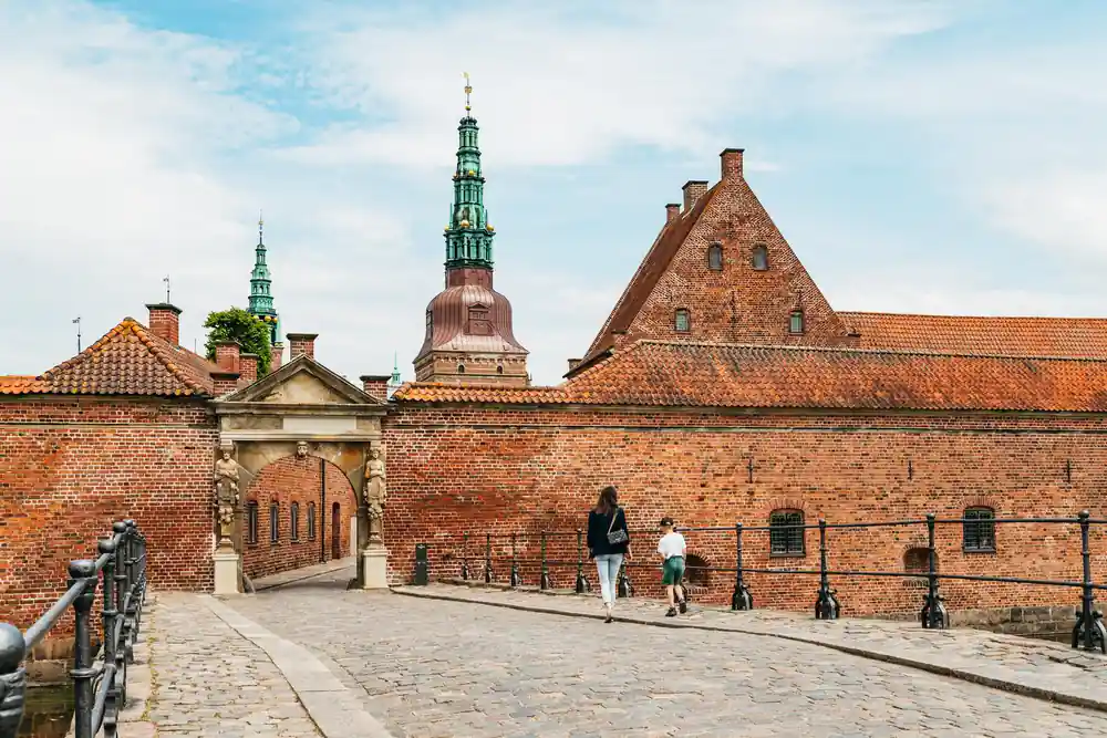 Red brick fortress courtyard with spire and entrance gate