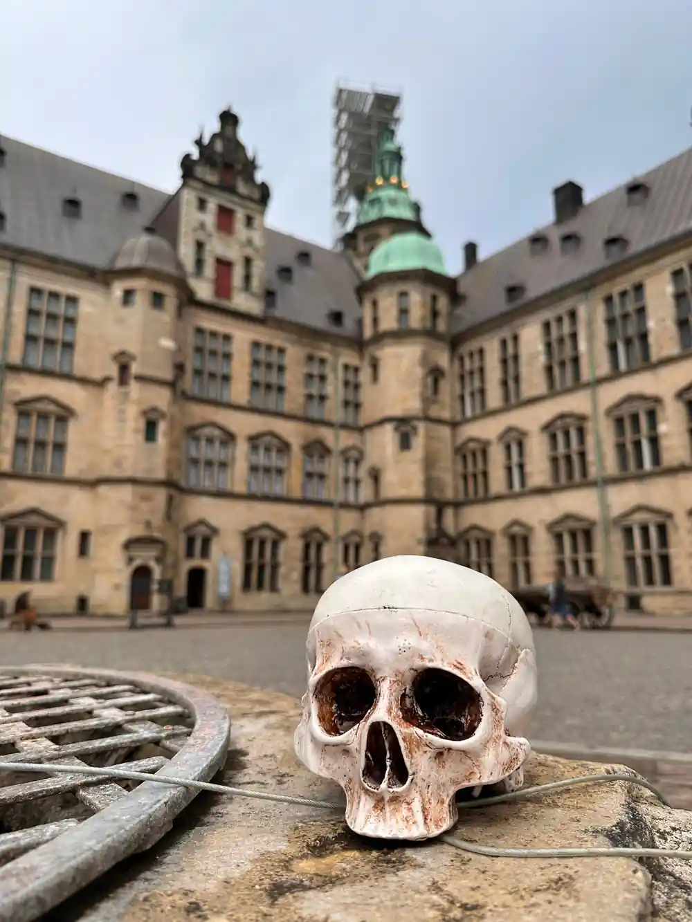 Skull prop on stone with medieval castle courtyard