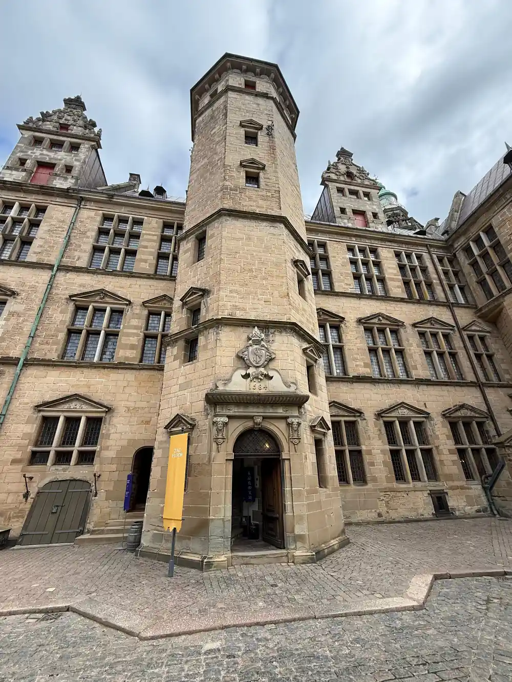 Stone castle tower with arched entrance and turret